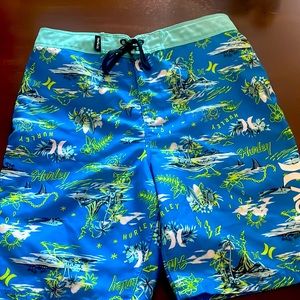 Boys Hurley swim shorts, blue with beaches, sharks, planes, and the brand Hurley